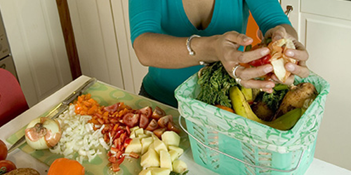 Lady filling food waste bin