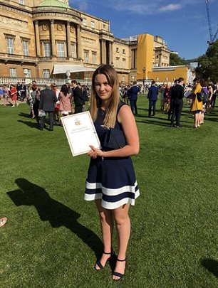 Megan Duncombe with her award in the gardens at Buckingham Palace