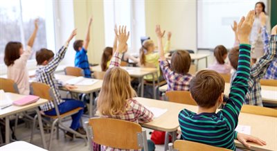 Children raising hand estyn report