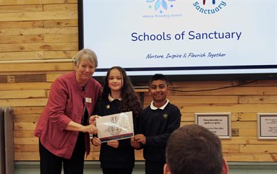 Cllr Lis Burnett awarding Head Girl and Head Boy with School of Sanctuary Certificate