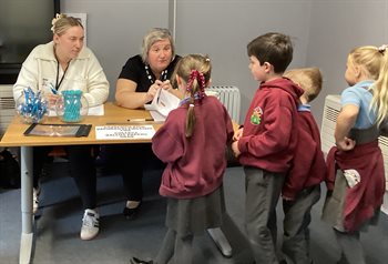 School children helping staff to count votes